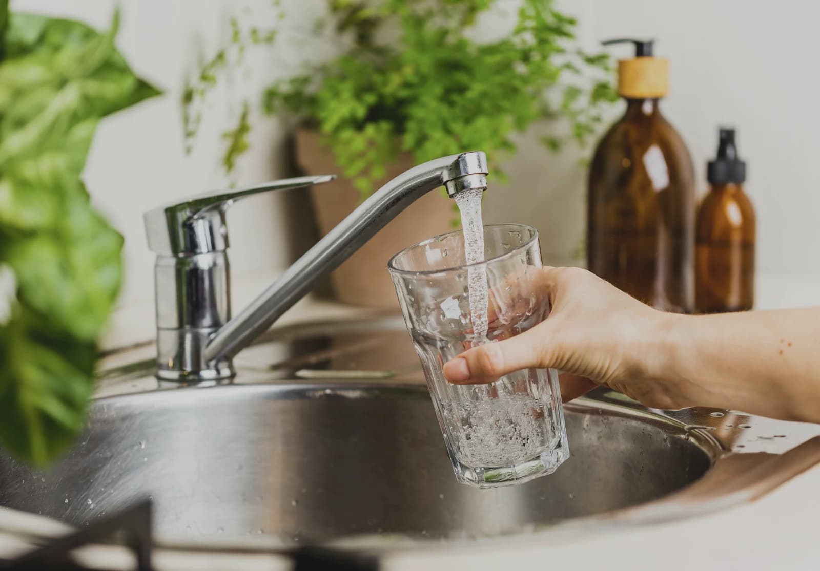Cheerful girl drinks fresh water